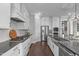 Modern kitchen with stainless steel appliances, dark countertops and flooring, and white cabinets at 200 Baskerville Ct, Holly Springs, NC 27540