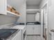 Well-organized laundry room with modern washer, dryer, storage cabinets, and sink at 200 Baskerville Ct, Holly Springs, NC 27540