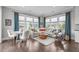 Inviting living room and breakfast area with large windows and stylish decor at 200 Baskerville Ct, Holly Springs, NC 27540