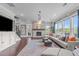 Spacious living room offers natural light, fireplace feature, and comfortable seating arrangement at 200 Baskerville Ct, Holly Springs, NC 27540