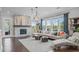 Inviting living room features stone fireplace, bright natural light, comfortable seating, and modern decor at 200 Baskerville Ct, Holly Springs, NC 27540