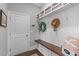 Well-organized mudroom with bench seating, storage hooks, and decorative elements at 200 Baskerville Ct, Holly Springs, NC 27540