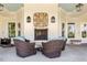 Cozy patio with wicker furniture, a brick fireplace, and views of the outdoor scenery at 200 Baskerville Ct, Holly Springs, NC 27540