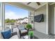 Cozy screened porch with outdoor furniture and mounted television at 200 Baskerville Ct, Holly Springs, NC 27540