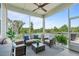 Screened porch with wicker furniture, ceiling fan, and view of the trees at 200 Baskerville Ct, Holly Springs, NC 27540