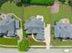 Overhead aerial view of the brick house shows its landscaped grounds and its proximity to neighboring houses at 204 Franconia Way, Apex, NC 27502