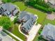 Bird's-eye view of a brick home, showcasing mature trees and a spacious driveway with manicured landscaping at 204 Franconia Way, Apex, NC 27502