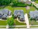 Stunning aerial view of the brick home showcases its sprawling layout, lush landscaping, and ample driveway space at 204 Franconia Way, Apex, NC 27502