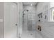 Stylish shower with glass door, tiled walls, built-in niche, and a sleek showerhead at 204 Franconia Way, Apex, NC 27502