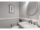 Elegant bathroom with marble countertop, round mirror, and classic fixtures at 204 Franconia Way, Apex, NC 27502