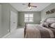 Comfortable bedroom with a neutral color palette, plush bedding, and a ceiling fan at 204 Franconia Way, Apex, NC 27502
