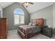 Inviting bedroom with a vaulted ceiling, arched window, and cozy furnishings at 204 Franconia Way, Apex, NC 27502