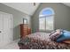 Comfortable bedroom with a vaulted ceiling, arched window, and cozy furnishings at 204 Franconia Way, Apex, NC 27502