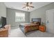 Neutral-toned bedroom with a comfortable bed, wooden furnishings, and ample natural light at 204 Franconia Way, Apex, NC 27502