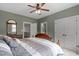 Bedroom with neutral walls, ceiling fan and a closet for storage space at 204 Franconia Way, Apex, NC 27502