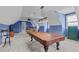 Spacious game room with billiards table and plush carpeting under a vaulted ceiling at 204 Franconia Way, Apex, NC 27502