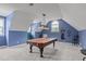 Large billiards room under a vaulted ceiling with an attractive light fixture at 204 Franconia Way, Apex, NC 27502