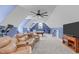 Spacious bonus room including a large comfy couch, exercise bike, and billiards table at 204 Franconia Way, Apex, NC 27502