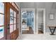 Entryway with marble floors, decorative door, and views into the blue office and hallway with half bathroom at 204 Franconia Way, Apex, NC 27502