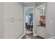 Hallway view leading to a dining area, showcasing built-in cabinets and shelving at 204 Franconia Way, Apex, NC 27502