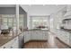 Island kitchen boasts granite countertops, modern appliances, and seamless transition into the dining area at 204 Franconia Way, Apex, NC 27502