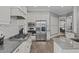 Modern kitchen with stainless steel appliances, granite countertops, and a tile backsplash at 204 Franconia Way, Apex, NC 27502