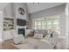 Bright living room with high ceilings, large windows, built-in shelving, fireplace, and comfortable seating at 204 Franconia Way, Apex, NC 27502