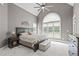 Spacious main bedroom featuring a vaulted ceiling, large windows, and stylish furnishings, creating a relaxing retreat at 204 Franconia Way, Apex, NC 27502
