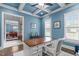 Blue office with white trim, coffered ceilings, large windows, and view into dining room from the doorway at 204 Franconia Way, Apex, NC 27502