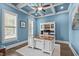 Bright blue office with coffered ceiling, large desk, built-in shelving, and multiple windows at 204 Franconia Way, Apex, NC 27502
