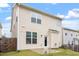 Rear view of home featuring neutral siding, a small patio, and a well-maintained lawn at 212 Sea Trail St, Hillsborough, NC 27278