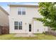 The home's backyard boasts neutral siding, a compact patio, and a lush, well-kept lawn at 212 Sea Trail St, Hillsborough, NC 27278