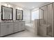 Luxurious bathroom with dual vanities, soaking tub, and glass-enclosed shower at 212 Sea Trail St, Hillsborough, NC 27278
