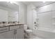 Bright bathroom featuring granite vanity top, undermount sink and bath and shower combo at 212 Sea Trail St, Hillsborough, NC 27278