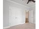 Bedroom features neutral carpet, fan, and en-suite bathroom and large closet at 212 Sea Trail St, Hillsborough, NC 27278