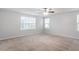 Spacious carpeted bedroom with neutral walls and natural light streaming through windows at 212 Sea Trail St, Hillsborough, NC 27278