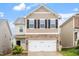 Charming two-story home featuring a stone-accented facade, neutral siding, and a two-car garage at 212 Sea Trail St, Hillsborough, NC 27278