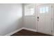 Bright foyer featuring wood floors, a white door with glass accents, and natural light at 212 Sea Trail St, Hillsborough, NC 27278