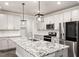 Bright kitchen featuring white cabinets, granite counters, stainless appliances, and a spacious island at 212 Sea Trail St, Hillsborough, NC 27278