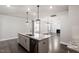 Kitchen with granite island and stainless steel appliances, that opens to the living area at 212 Sea Trail St, Hillsborough, NC 27278