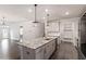 The kitchen has a large island with granite countertops, modern lighting, and an open floor plan at 212 Sea Trail St, Hillsborough, NC 27278