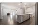 Open-concept kitchen showcasing a large island, granite countertops, and stainless steel appliances at 212 Sea Trail St, Hillsborough, NC 27278