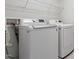 Laundry room featuring white front-load washing machine and white dryer at 212 Sea Trail St, Hillsborough, NC 27278