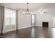 Open-concept living room with large windows, fireplace and hardwood floors at 212 Sea Trail St, Hillsborough, NC 27278