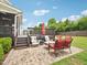 Brick patio with outdoor seating and a view of the multi-level deck in the well-maintained backyard at 214 Ashdown Forest Ln, Cary, NC 27519