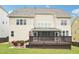 Spacious backyard featuring an expansive deck with a screened-in porch for outdoor enjoyment at 214 Ashdown Forest Ln, Cary, NC 27519