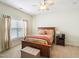Comfortable bedroom featuring a wood bed frame, a ceiling fan, and neutral tones at 214 Ashdown Forest Ln, Cary, NC 27519