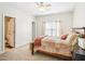 Comfortable bedroom featuring a wood bed frame, a ceiling fan, and neutral tones at 214 Ashdown Forest Ln, Cary, NC 27519