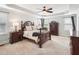 Main bedroom with tray ceiling, windows and dark wood furniture at 214 Ashdown Forest Ln, Cary, NC 27519