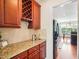 Butler's pantry with cherry cabinets, granite countertops and wine rack at 214 Ashdown Forest Ln, Cary, NC 27519